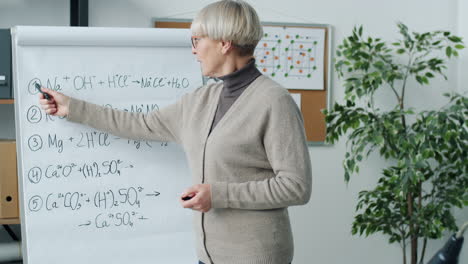 chemistry teacher presenting on whiteboard