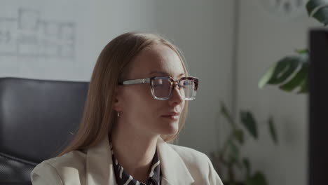 focused female architect working on desktop computer in office