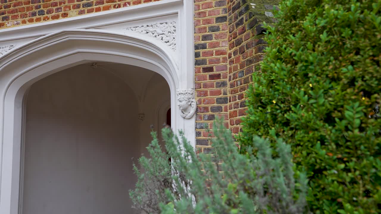Discover a tranquil courtyard retreat at Fulham Palace, where lush foliage and historic architecture transport you to a bygone era of English splendor.