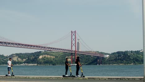 25 de abril bridge in lisbon with electric scooters