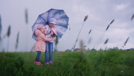 children hide under an umbrella from the rain 1