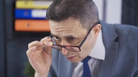 serious and focused mature businessman working on laptop with full attention.