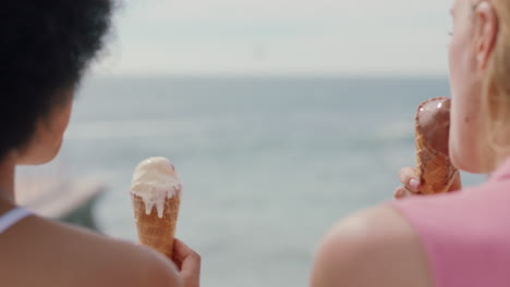 beautiful women eating ice cream on beach girl friends enjoying delicious soft serve relaxing on warm summer day 4k footage