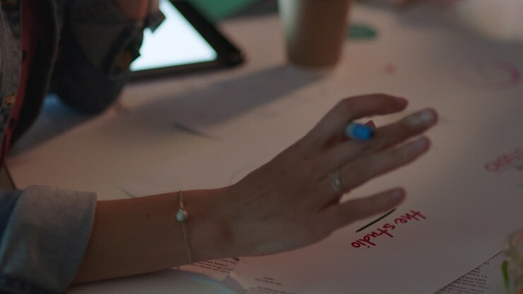 close up hands business people working late marketing team designing company logo brainstorming ideas planning creative project deadline in office at night