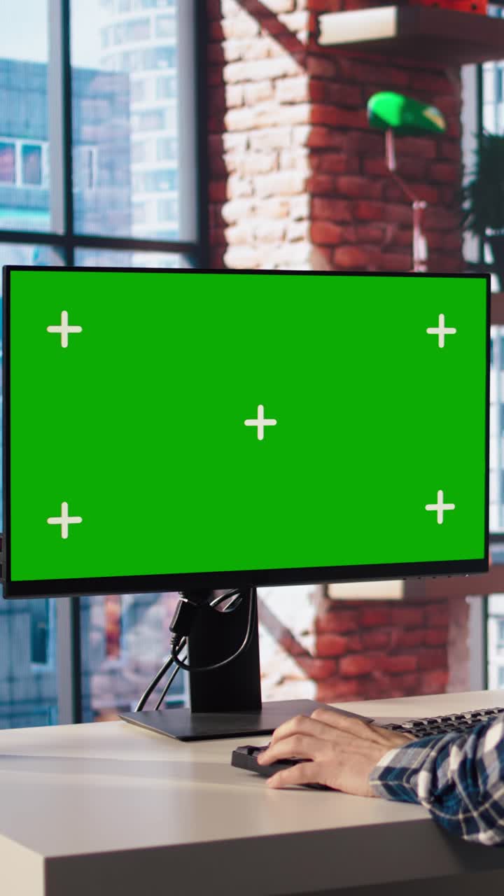 Vertical video Remote worker doing project research, typing on green screen device