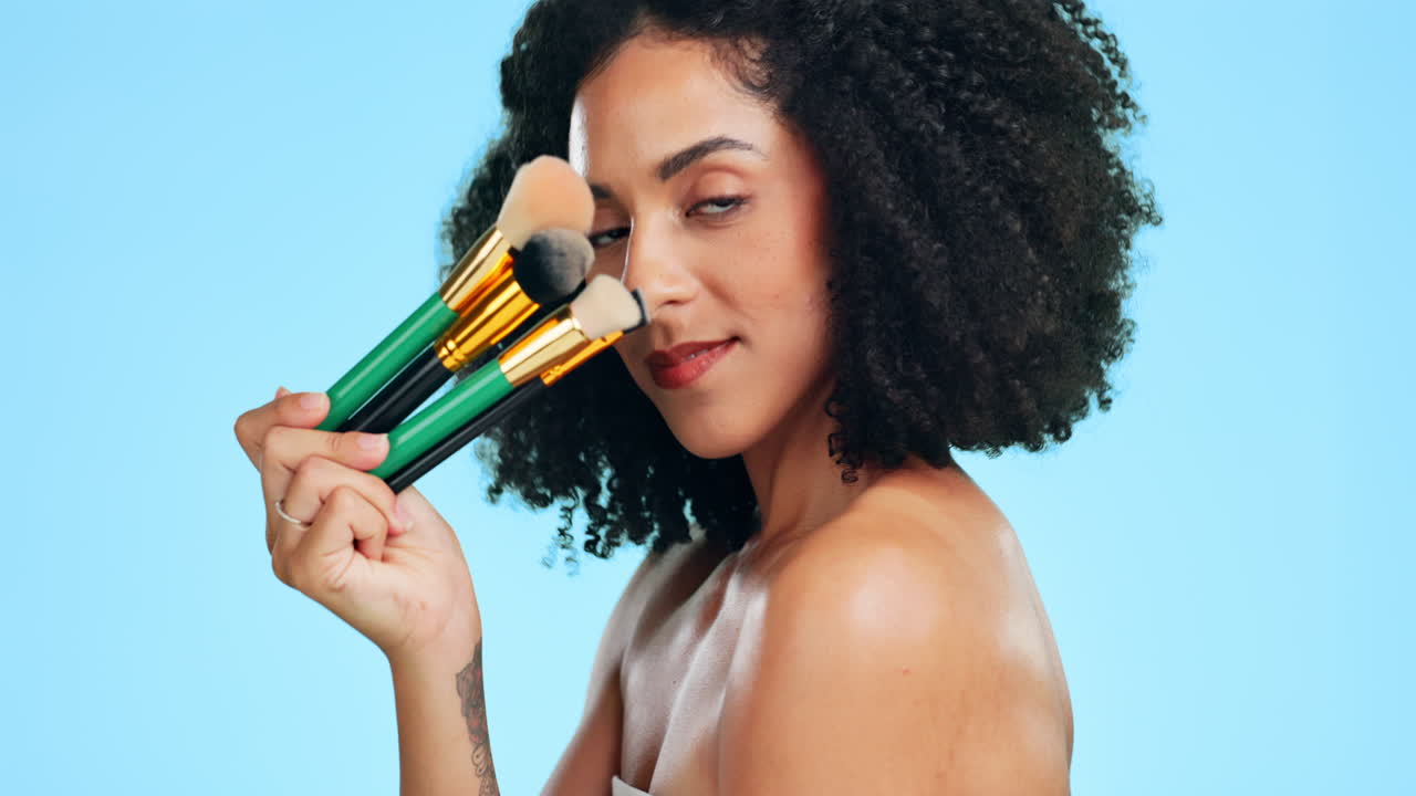 Beauty, makeup brush and face of woman in studio