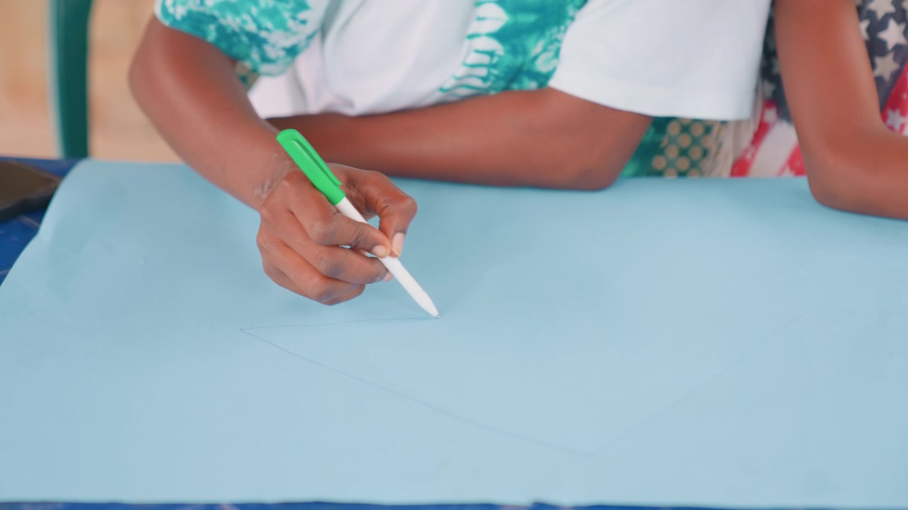 Mother designs with precision marks. Precise tracing and measurement during handmade fabric work session. Calm domestic setting where mother meticulously marks and prepares fabric for sewing