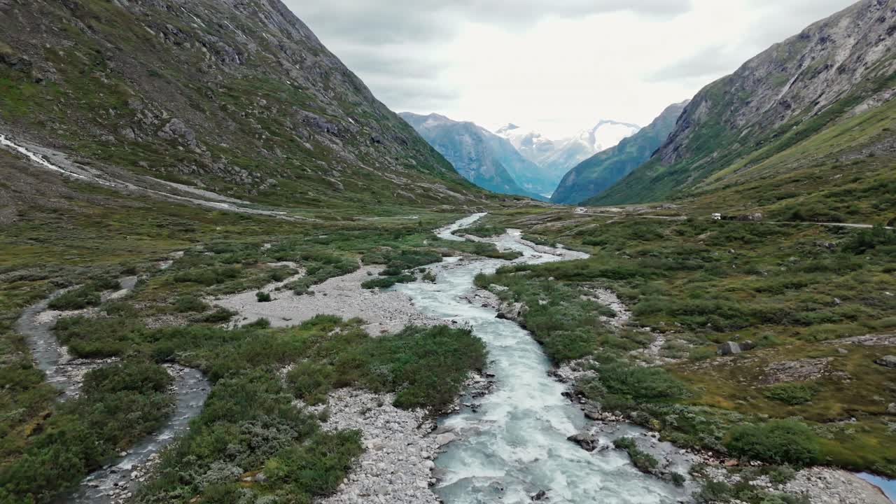 Icy mountain river and valley of Norway, aerial drone view