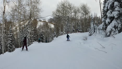 snowboarder going down slope skiing at steamboat springs colorado