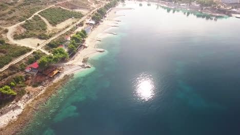 the picturesque town of ksamil with the adriatic sea waves crashing against the shoreline along the albanian riviera in albania