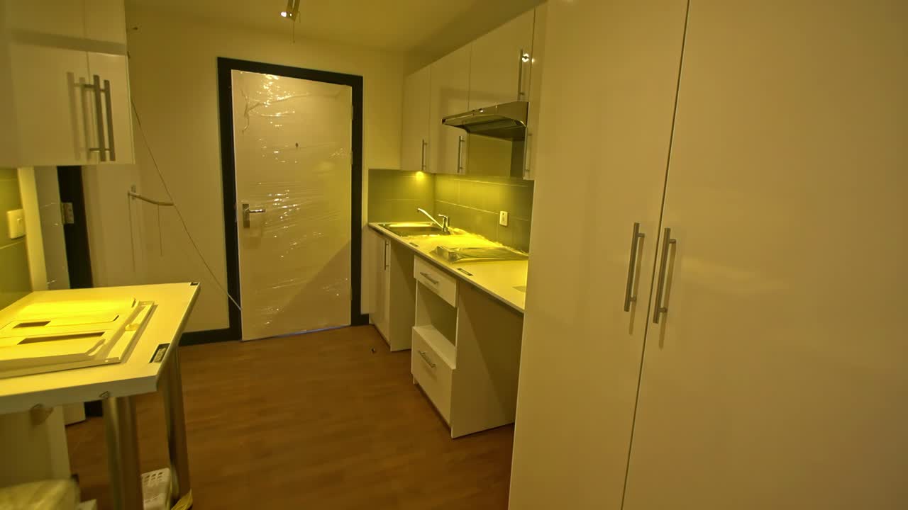 Empty modern interior hallway glows under eerie green lighting in newly constructed building