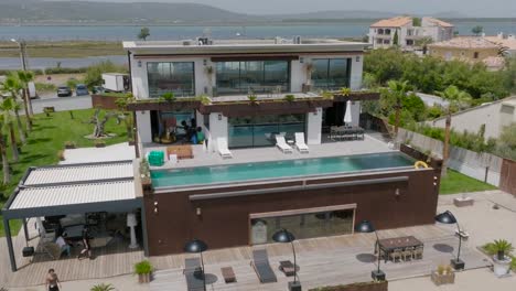 establishing shot of people getting ready to sun lounge at a villa in frontignan