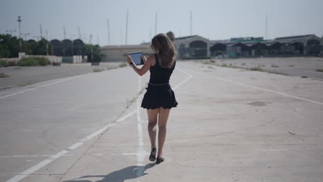 woman taking a selfie on an empty road