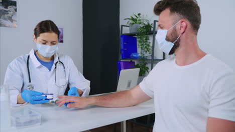 doctor examining patient's pulse oximetry