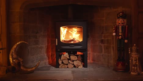 Lit-wood-burning-stove-in-winter-fireplace