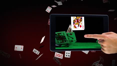 hand using tablet showing poker cards video