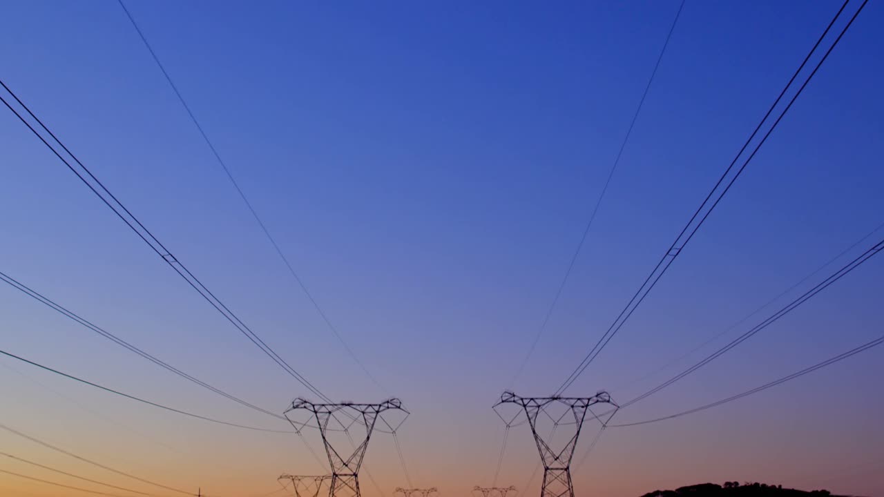Electricity pylons during sunset 4k