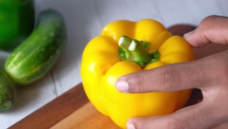 cutting yellow bell pepper and cucumber