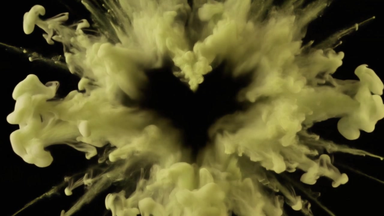 Yellow Smoke Forming a Heart Shape Against a Black Background