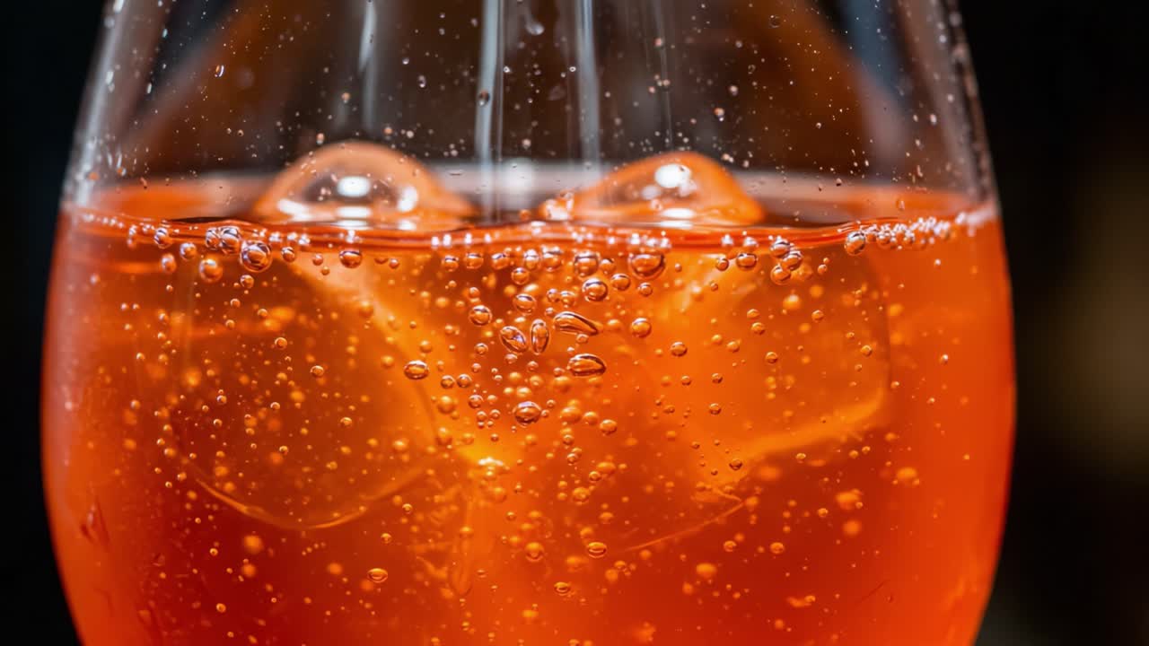 Refreshing Sparkling Beverage in a Glass: A Close-Up Look at Bubbles and Ice Cubes Creating an Inviting Drink Experience