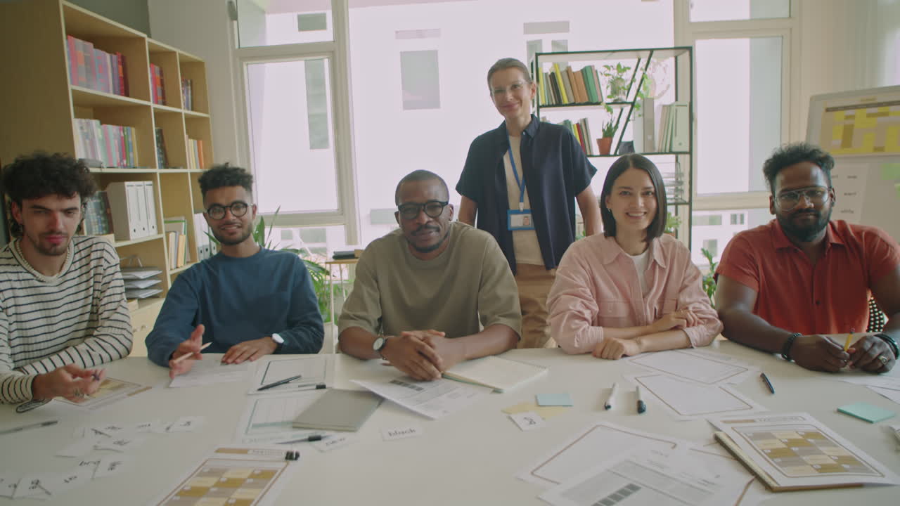 Group Portrait of Immigrant Students and Female Teacher in Classroom