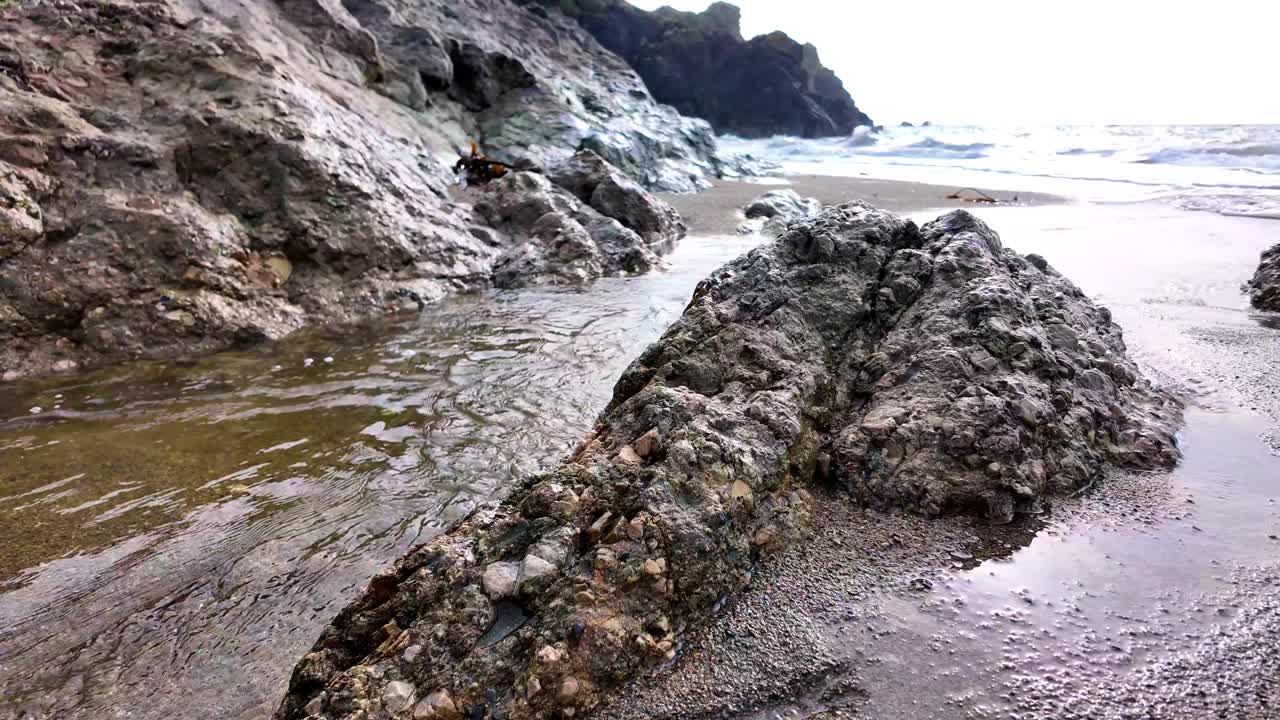 corriente de movimiento lento que fluye a través de la roca al mar waterford irlanda