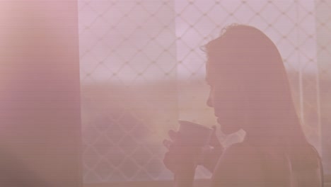 Brunette-woman-drinking-coffee-in-the-morning-looking-out-of-window,-slow-motion