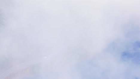 Aerial-Top-Down-Orbital-View-Through-Clouds-of-Vehicles-Driving-Along-Coastal-Curved-Road-Through-Pine-Forest-in-Port-Alberni-Region,-British-Columbia-Canada