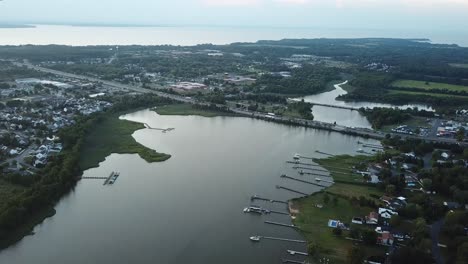 tilt down aerial view on kent island, maryland usa in twilight, skyline and interstate highway over chesapeake bay