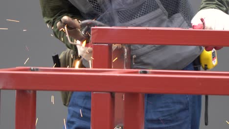 construction worker welding metal tubular construction close-up
spot welding of metal with elecrode