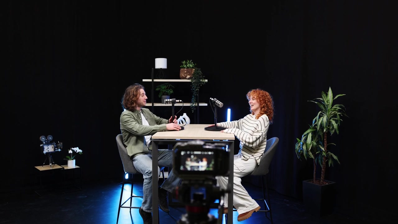 Man and Woman Sit Down to Record a Podcast Interview