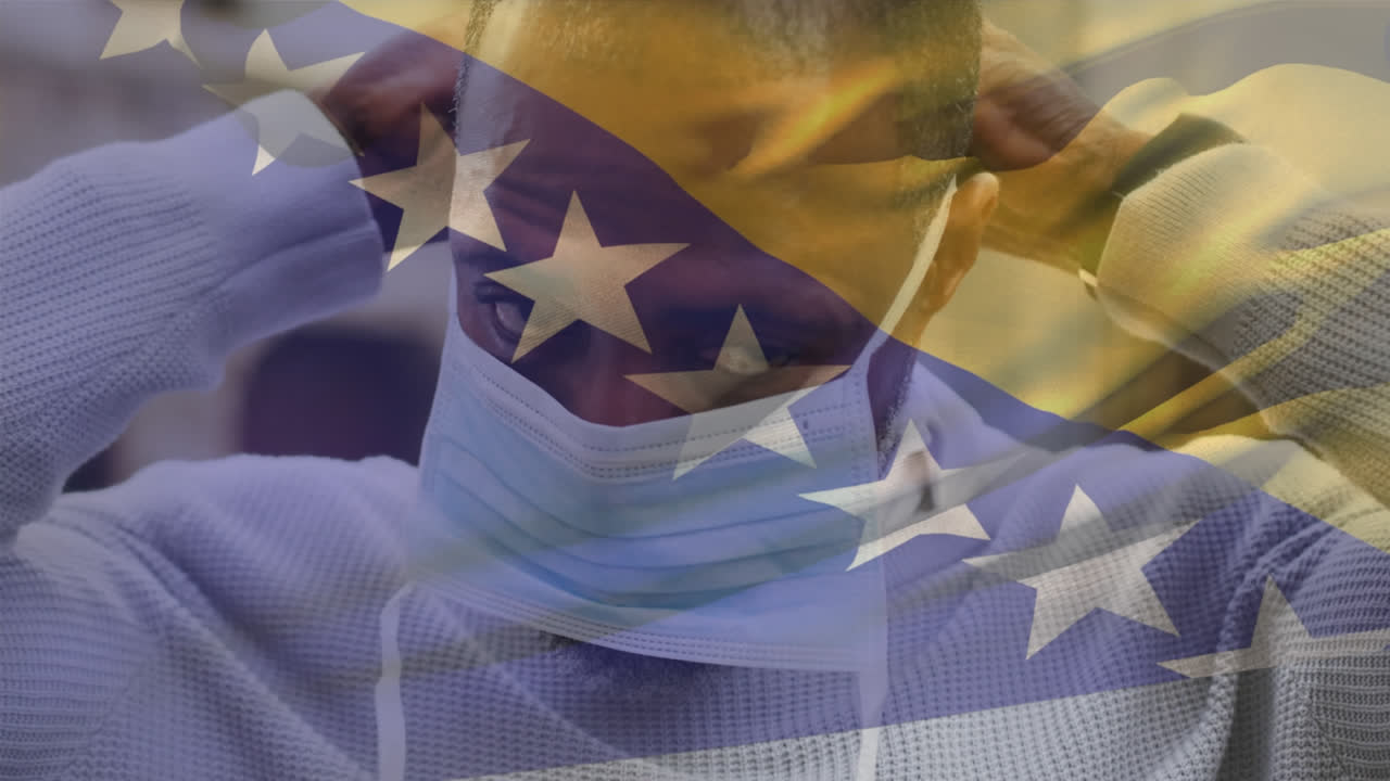 보스니아 헤르체고비나에서 길거리에서 얼굴 마스크를 쓰고 있는 아프리카계 미국인 남자를 향해 흔들리는 애니메이션