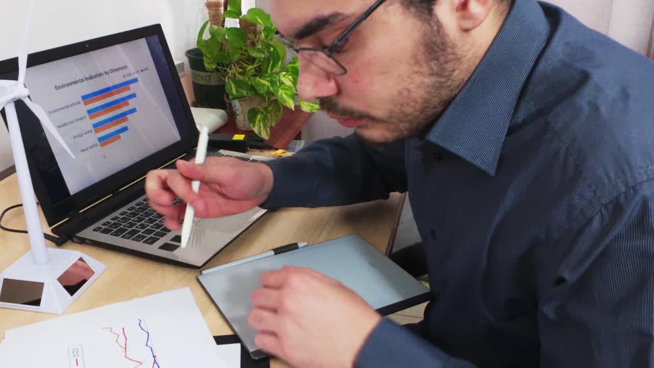 Engineer Pointing to Data on a Digital Tablet with a Stylus