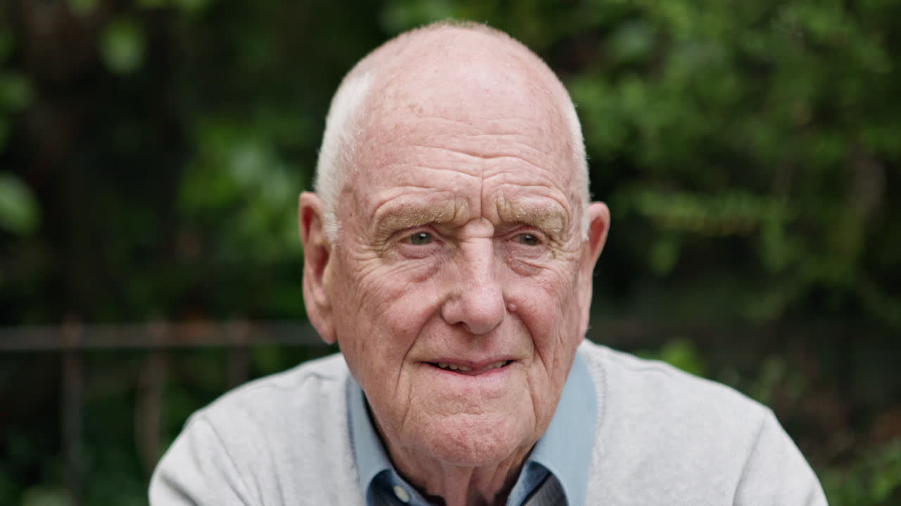 Portrait of an elderly man in a garden