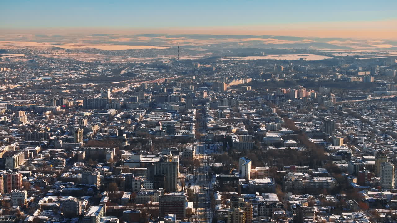 Aerial drone view of the city center covered in snow. Sunrise during winter in Chisinau, Moldova