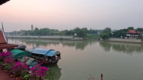 houseboat on calm canal with flowers