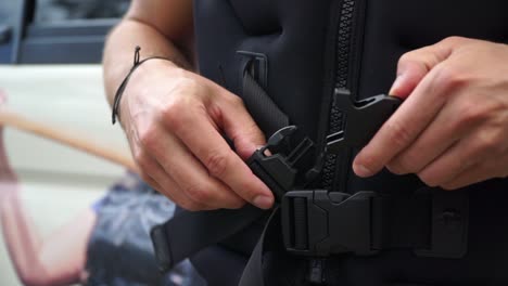 slowmo - life jacket being zipped up, clipped together and fasten - close up