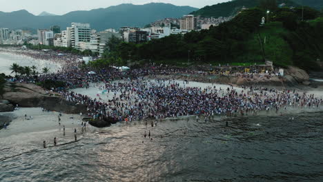 a large crowd of people on the famous ipanema beach, rio de janeiro, brazil, aerial shot