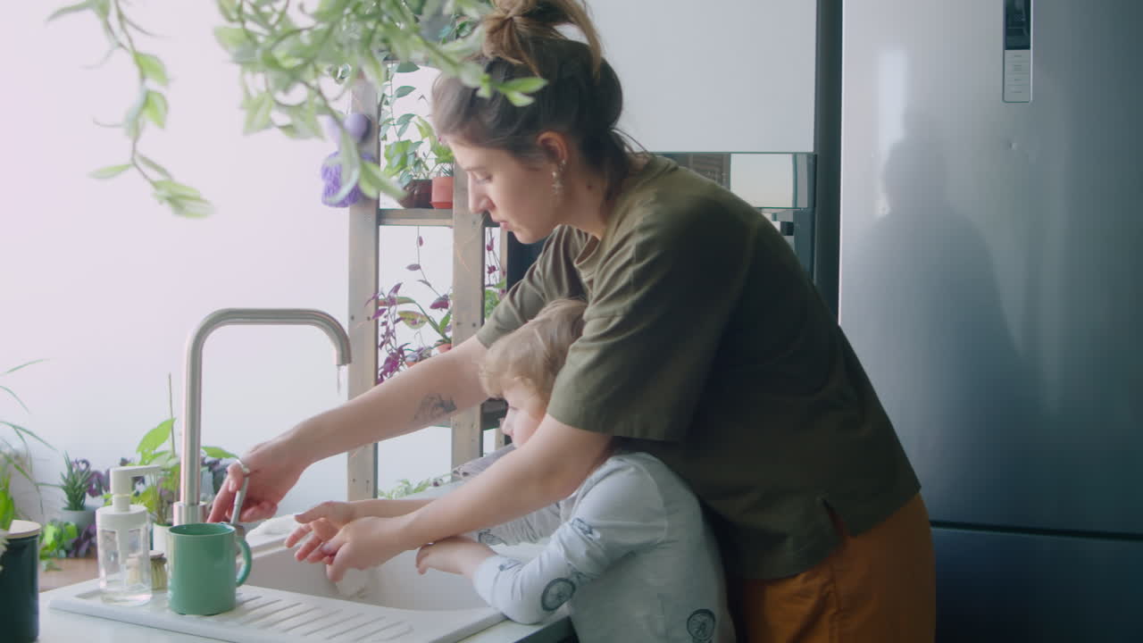 Mother Helping Son with Washing Hands at Home
