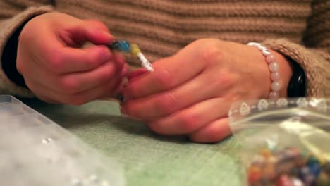 closeup shot of a female making fashion accessories, handmade jewellery bracelets with beads