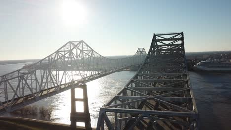 bright sunlight shining over crescent city connection over mississippi river in lousiana, usa