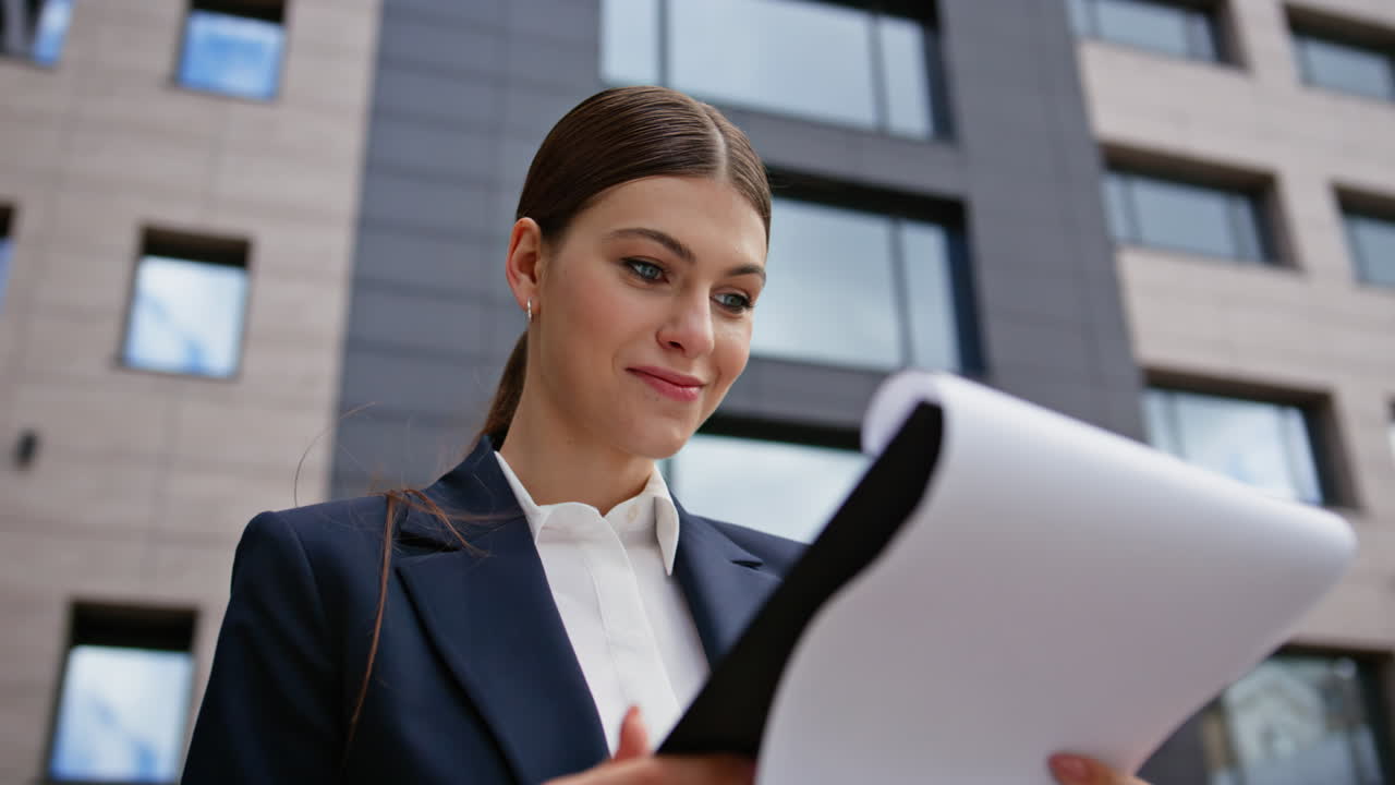 Focused businesswoman reading paperwork downtown closeup. Professional woman