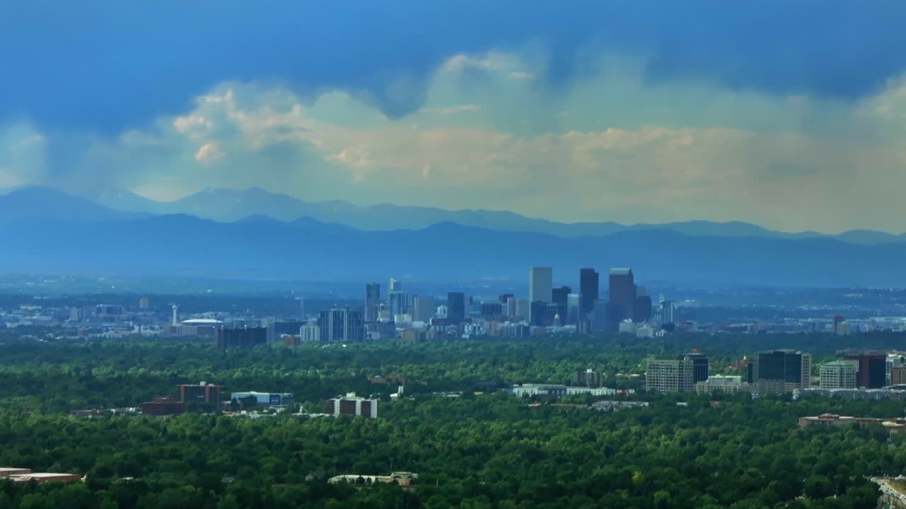 Downtown Denver skyscraper cityscape interstate i25 traffic sunset aerial drone Colorado Denver Tech Center Centennial Lone Tree Aurora RTD light rail train Front Range Rocky Mountains circle right