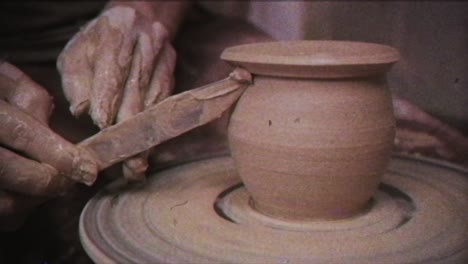 the potter makes a jug of clay. vintage effect. a man makes a vase on a potter's wheel