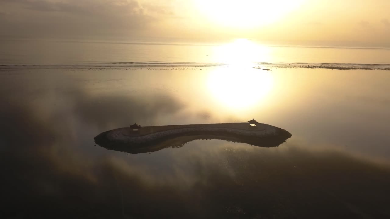 Aerial drone view of Pantai Karang Beach in Sanur, Bali at sunrise