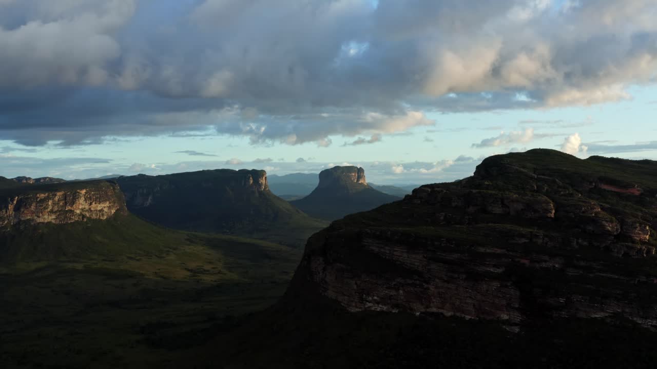 Trucking left flying drone landscape shot of the stunning Capao Valley from the Mount of Pai Inácio in the Chapada Diamantina national park in northern Brazil on a warm sunny summer evening.