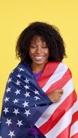 smiling woman wrapped in american flag