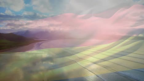 animación de la bandera de colombia ondeando sobre una playa soleada y las olas rompiendo en el mar