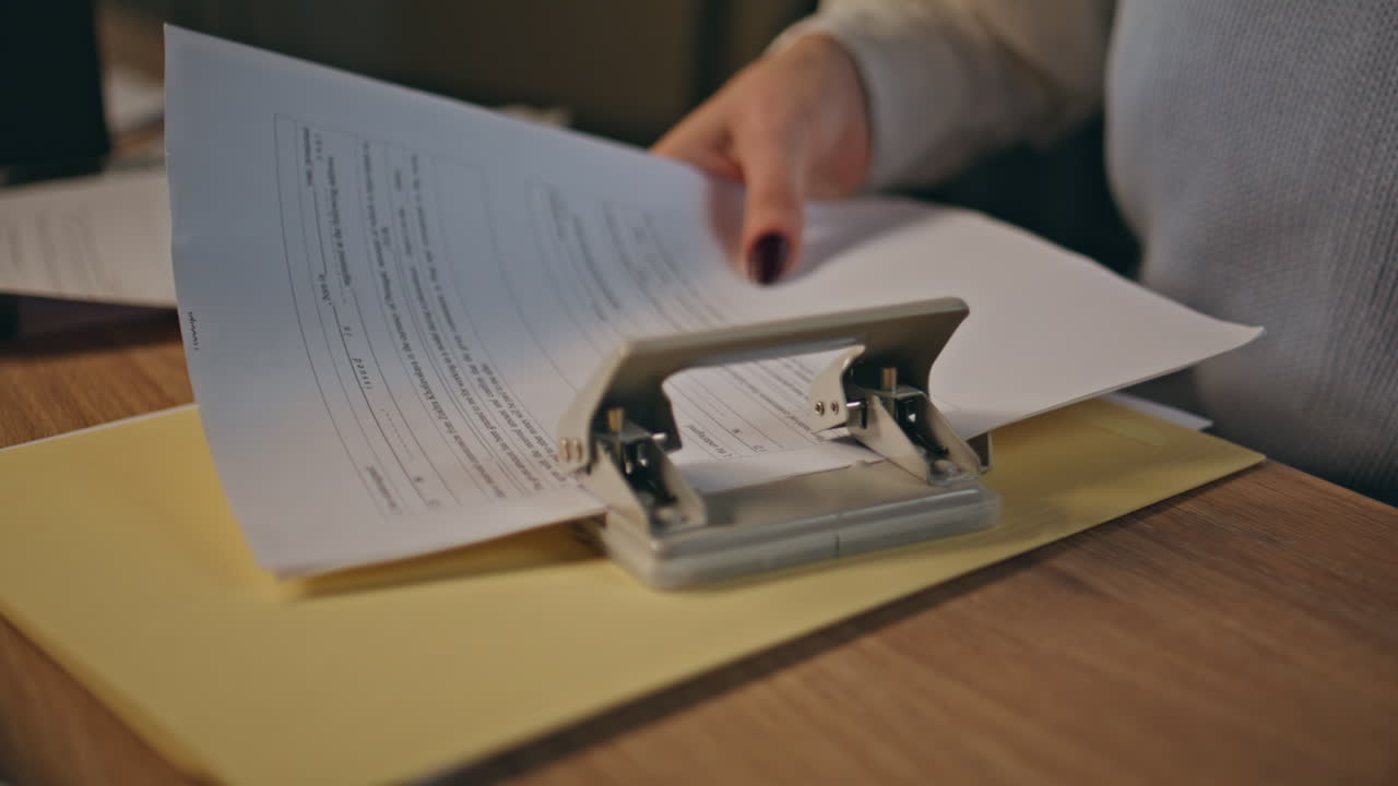 Businesswoman hands staple documents at coworking closeup. Lady doing paperwork