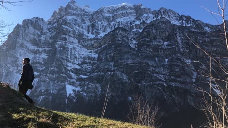 Solo-traveller-discovering-mount-Wiggis-in-Netstal,-Switzerland,-wide-shot